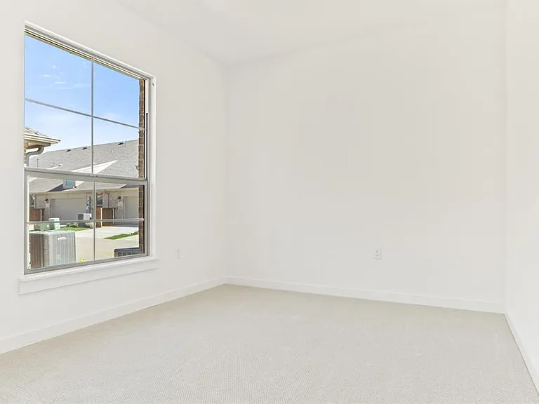 Comfortable second bedroom with walk in closet, perfect for guests, family, or a home office.