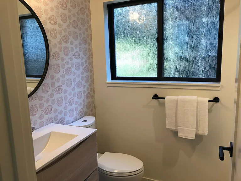 Custom bath with Schoolhouse lighting and Hansgrohe fixtures