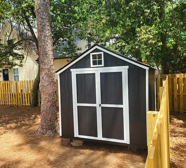 Storage shed in fenced in backyard
