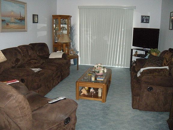 comfy & cozy living room with sliders to deck & utililty closet
