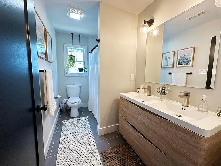 Upstairs full bath with double vanity.