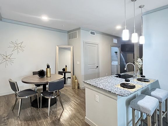 Kitchen and dining room area, leading to storage and laundry room