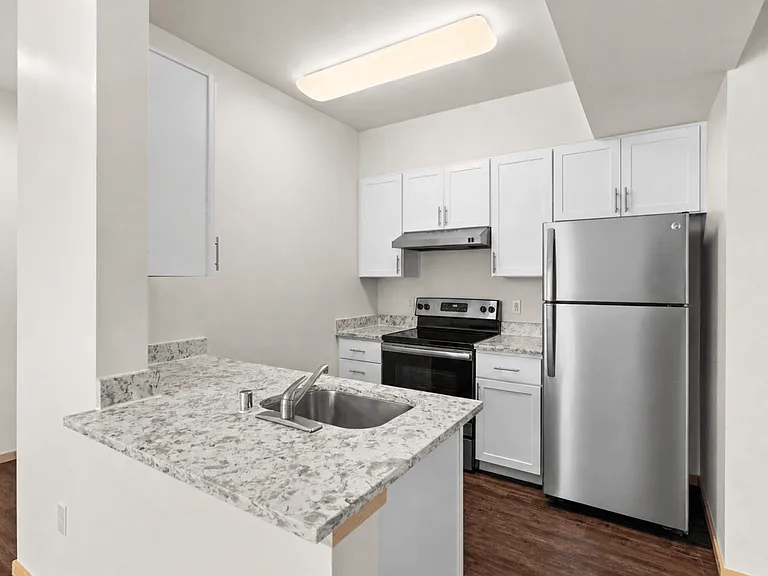 Kitchen with breakfast bar and stainless steel appliances Kitchen with breakfast bar and stainless steel appliances