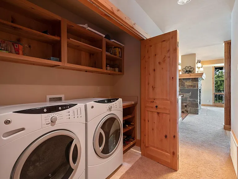 In-condo laundry area with oversized storage pantry