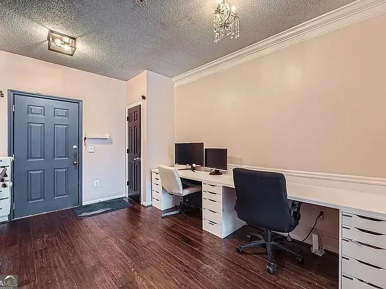 Roomy coat closet and double work station make an excellent use of space, leaving plenty of room to move through to the main living area.