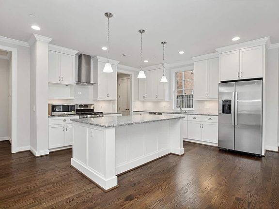 Island anchors the cook zone, pendants mark the center