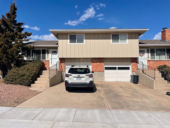 Front of house with separate 
entrance, garage, and parking space. Low maintenance landscaping.