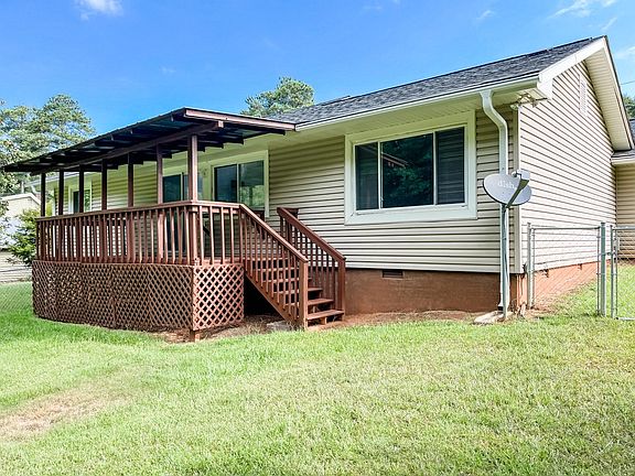 Fenced in backyard and covered deck.