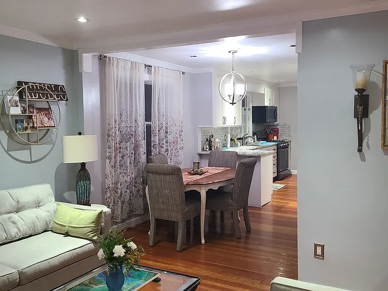 The home's bright, open-concept main level creates an easy flow between the living room, dining area, and recently renovated kitchen