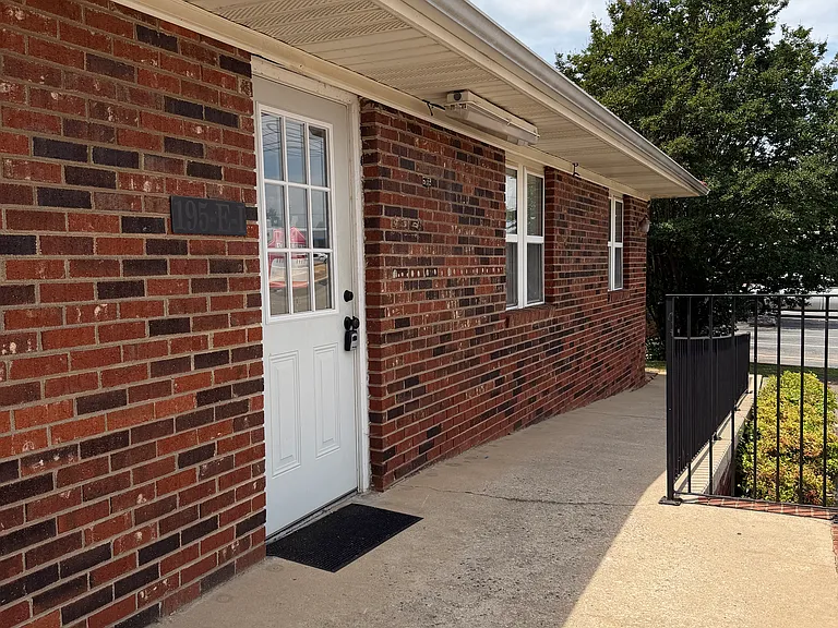 Well-maintained brick storefront with clean, dedicated outdoor space, offering a polished, professional first impression for your busines.
