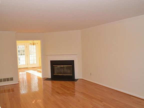 Walking in front door to living room with fireplace