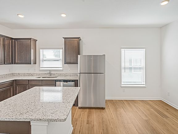 Designer kitchen with stainless appliances, granite countertops, and recessed lighting.