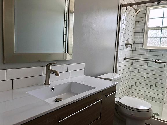 A large shower is adjacent to the second bedroom.