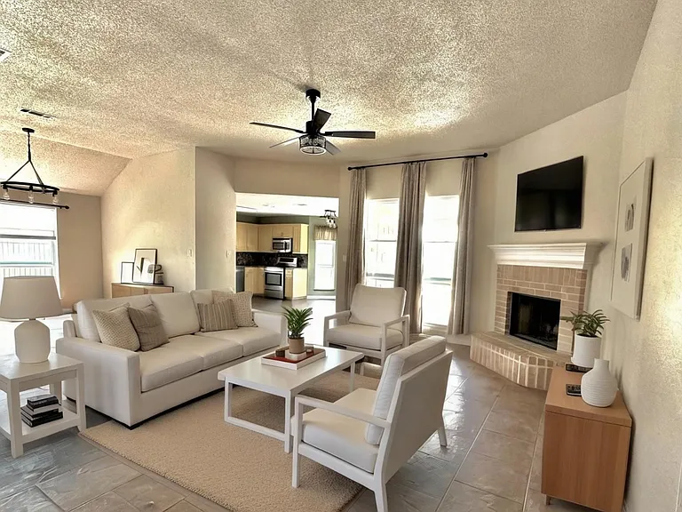 Living room with wood-burning fireplace.