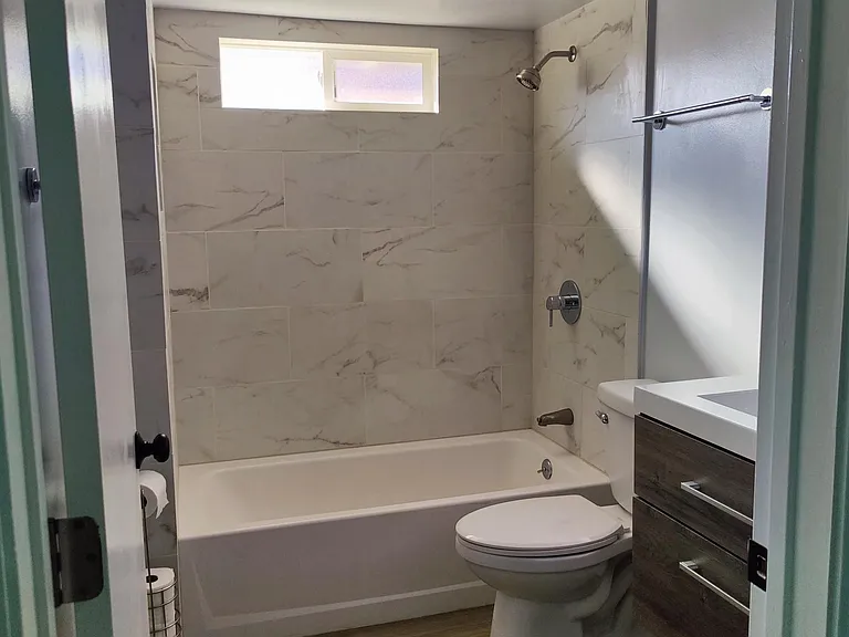 Tile shower/tub combo, floating vanity with drawers and medicine cabinet.