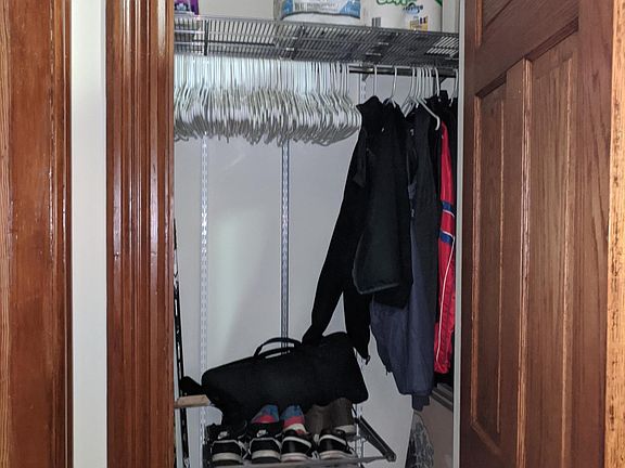 Coat closet with ELFA shelf and shoe racks