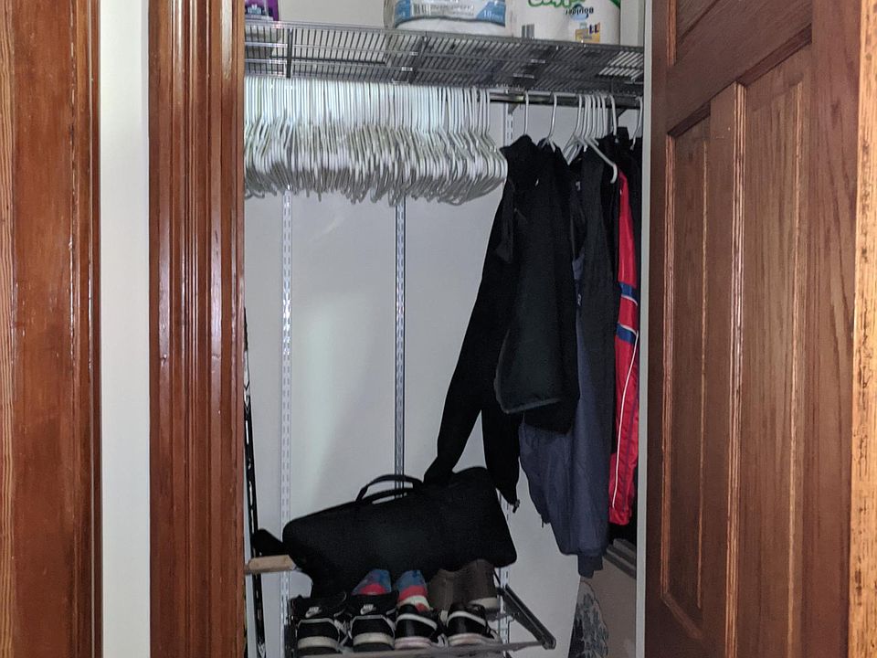 Coat closet with ELFA shelf and shoe racks