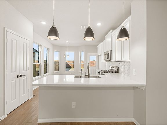 Kitchen with peninsula and pendant lighting