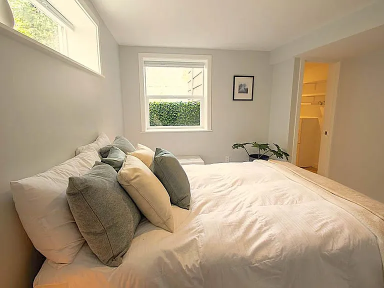Primary Bedroom with walk-in closet that has built-in dresser and lots of shelves.
