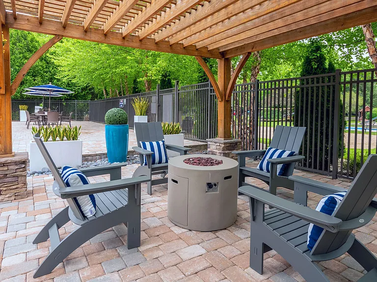 Cozy up by our firepit beneath a chic pergola, a perfect evening retreat by the pool.