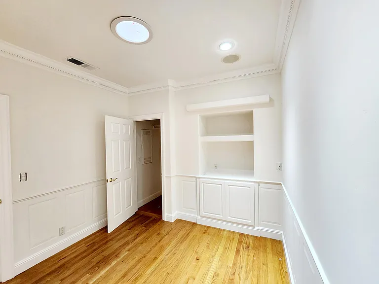 Bedroom #1 with walk in closet and built in cabinetry.