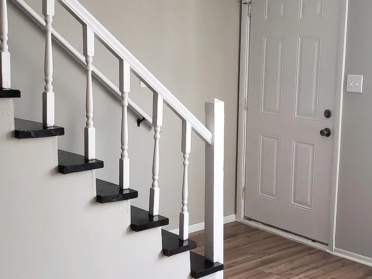 View of the front door and stair entrance area.