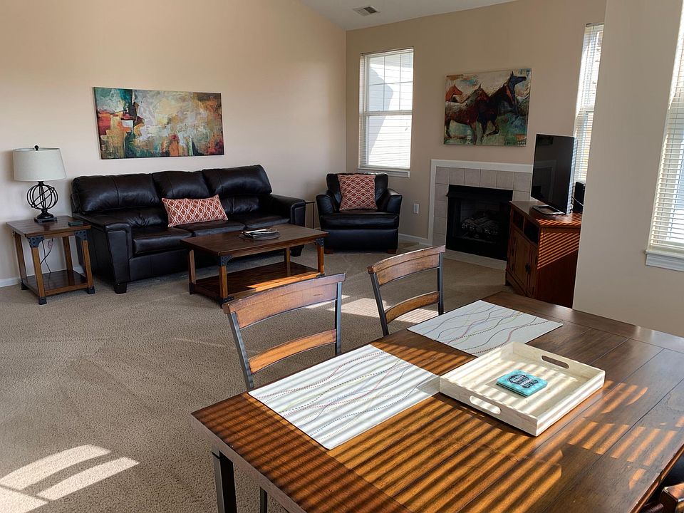Spacious and Sunny Living Room with Vaulted Ceilings and Gas Fireplace