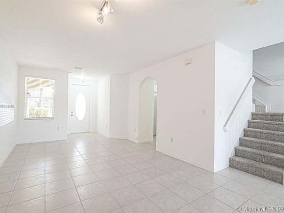 Entrance with view of the access point to the laundry room, powder room and garage.