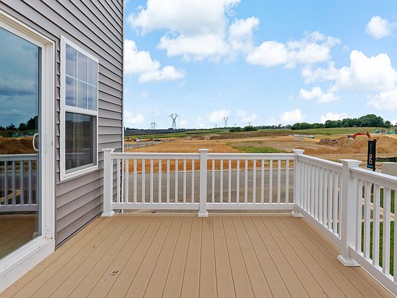 Spacious balcony in York II South Brook Townhome by DRB Homes with scenic views and comfortable seat