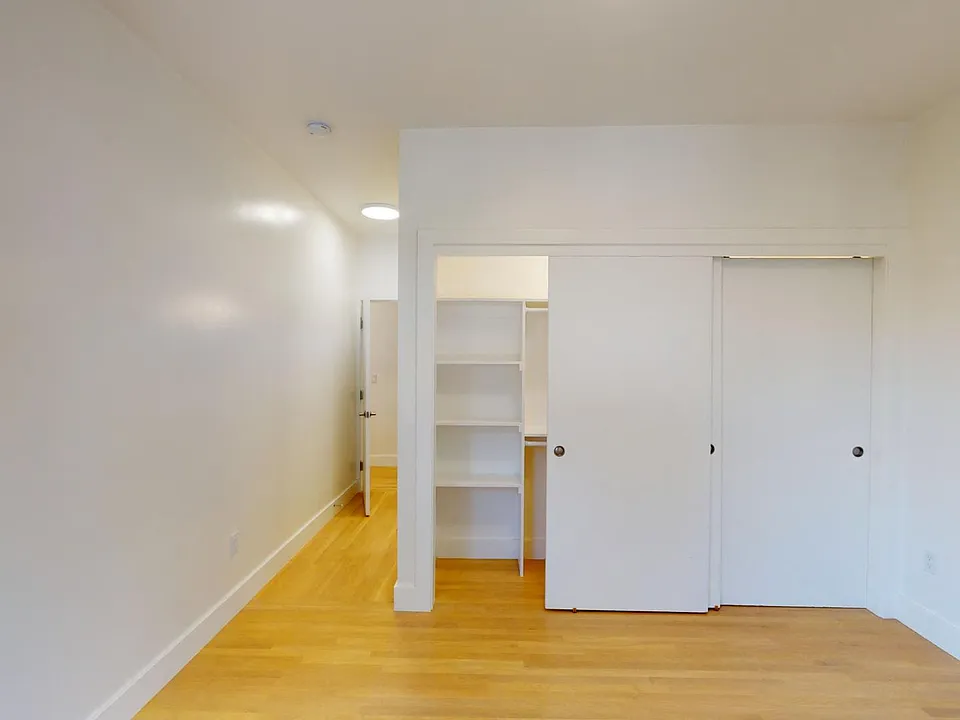 Bedroom with a wood-like flooring and a closet