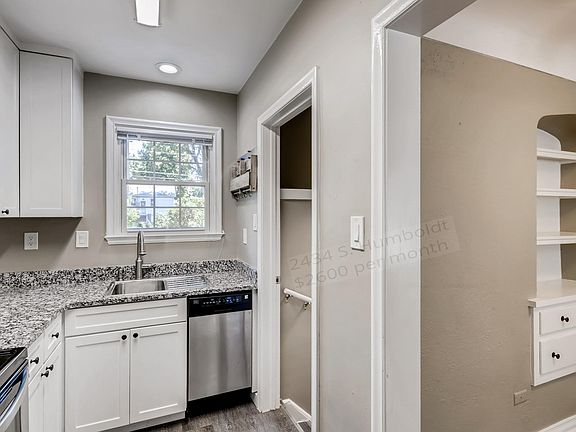 Kitchen with view of backyard and back stairway