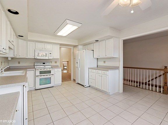 Ceramic tile, white woodwork and cabinetry add to this spacious kitchen!