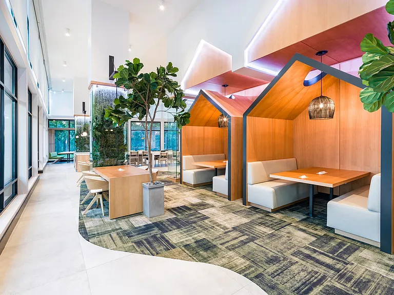 Flexible workspaces with private pods and collaborative seating offer a stylish, functional escape for work or leisure.