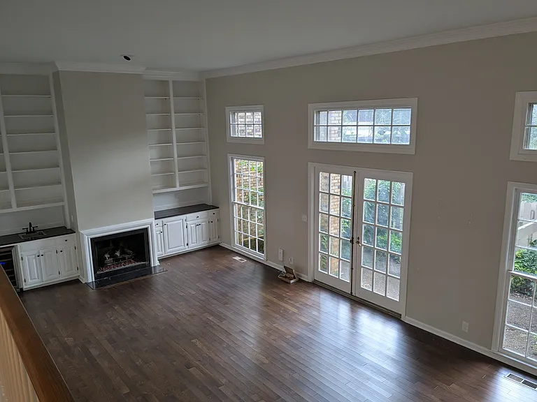 living room with wet bar, built-ins, gas fireplace and access to the private patio