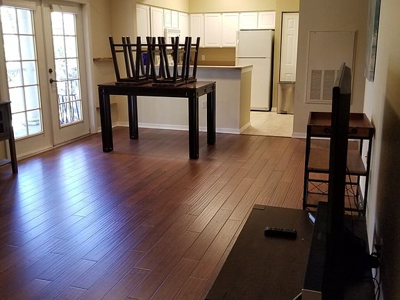 spacious dining room with doors that lead out to balcony