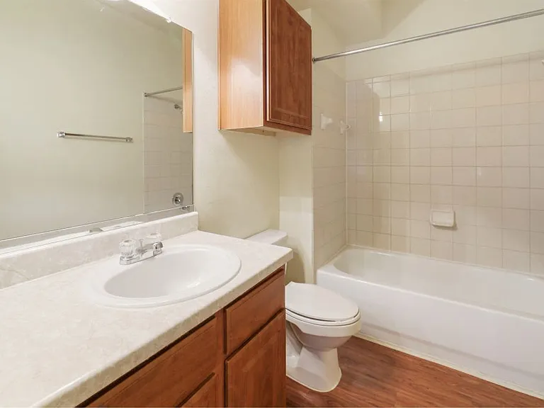 Spacious bathroom with tiled bath and large vanity Stonehaven Apartments in Houston, TX