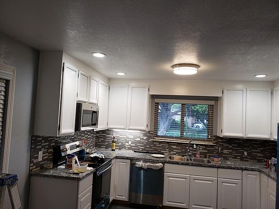 Kitchen with All NEW Appliances (built-in microwave, electric stove, dishwasher and 25 cu ft refrigerator with built in ice -maker) Recess and under-counter lights