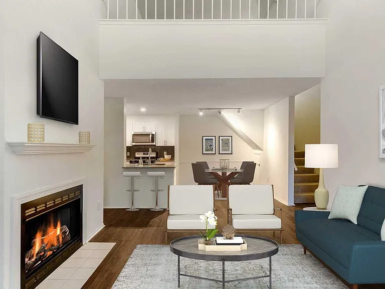 Renovated Package I kitchen, living, and dining areas with hard surface plank flooring