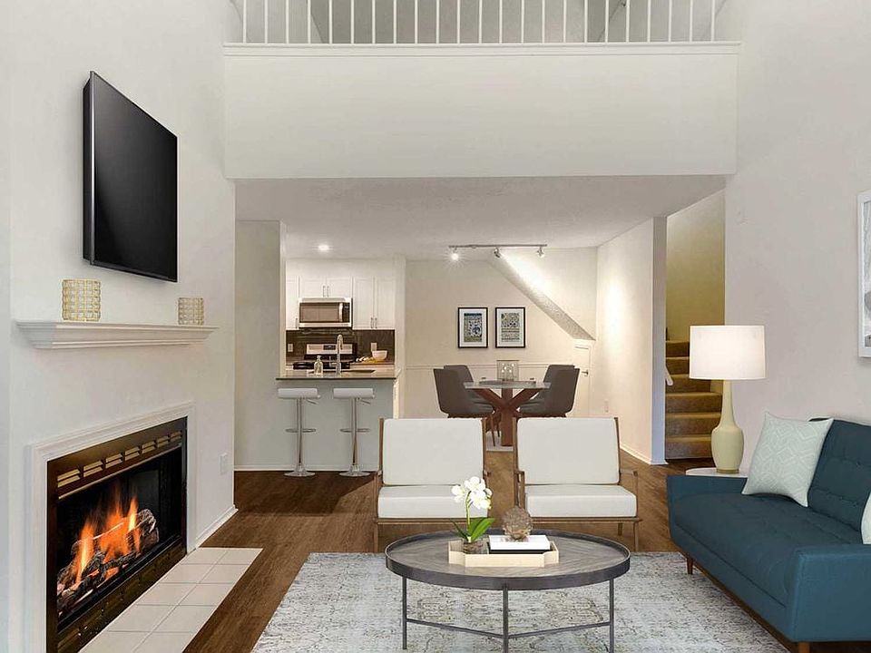 Renovated Package I kitchen, living, and dining areas with hard surface plank flooring