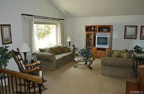 Large formal living room with oversized picture window, light an