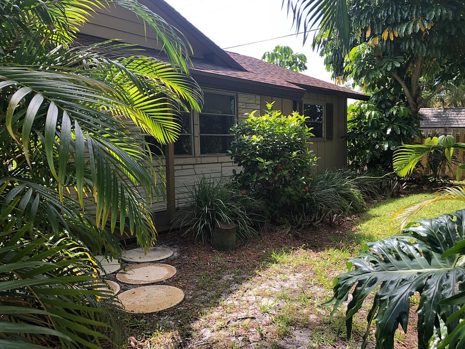 House is tucked in behind a Nice yard
