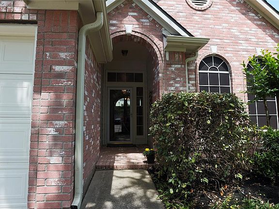 Front entry with storm door & pretty bricked porch