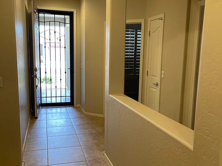 Divided hallway with 2 bedrooms and 1 bathroom to the right.