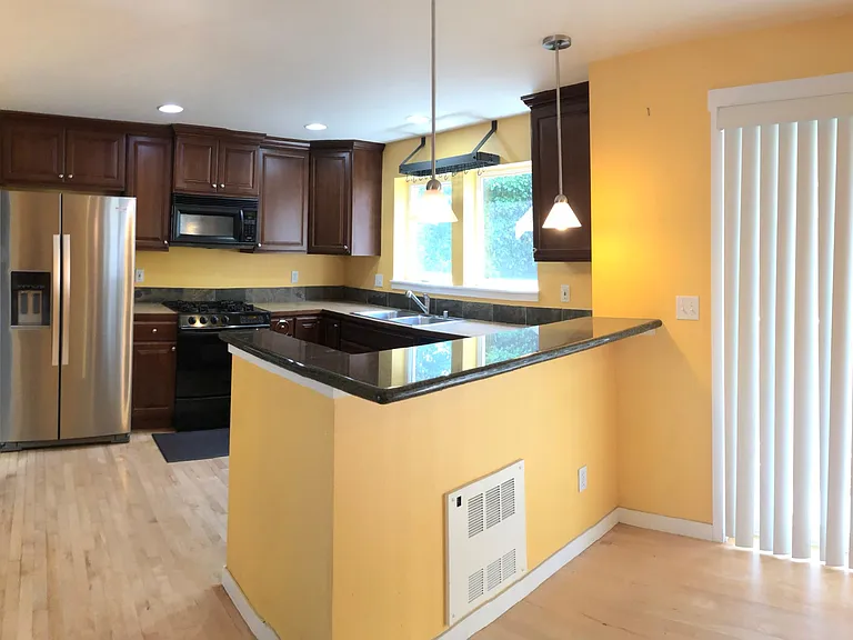 open concept kitchen & dining area with granite breakfast nook and balcony