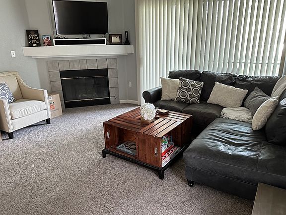 Living room with gas fireplace and slider