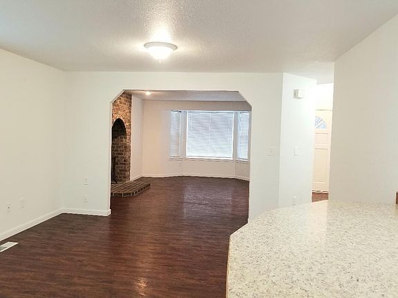 kitchen view through dining room into living room