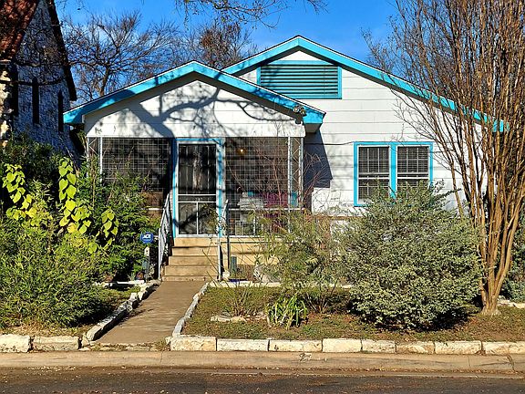 Front view of house from street. Large screened in front porch.