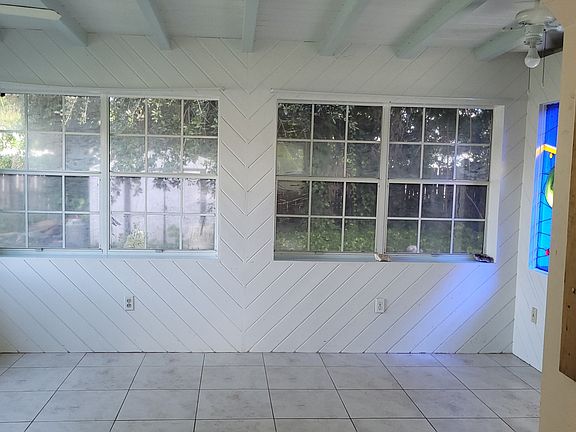 Sunroom with french doors & stain glass window ...