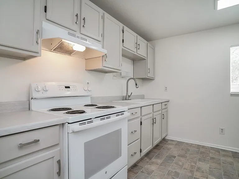 Cheerful Kitchen with Window and Tastefully Upgraded Counter, Sink & Faucet