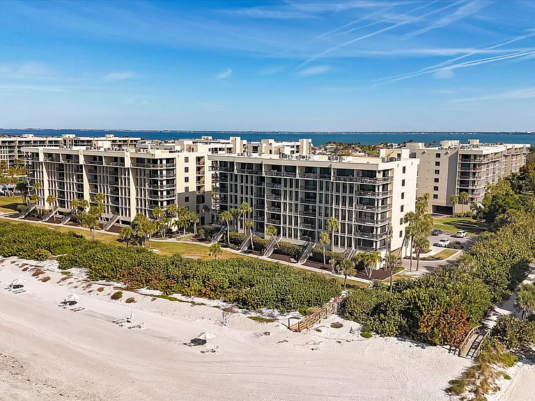 Beach directly in front of building 9 with Beachplace-specific lounge chairs and umbrellas for use by tenants